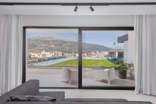 a living room with a large window with a view at No Stars - Premium Hotel Apartments in Ioannina