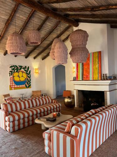 a living room with couches and a fireplace at Cortijo Genesis in Gaucín