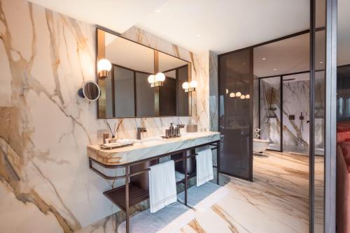 a bathroom with a sink and a large mirror at Glens Palas Istanbul Nisantasi in Istanbul