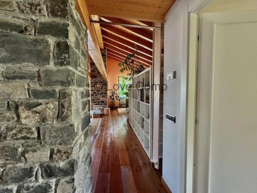 a hallway of a house with a stone wall at Villa 3 Olivi - Lenno by LoveComo in Lenno