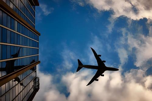 an airplane flying in the sky near a building at Flat Hotel Executivo Ibirapuera Moema (Apto 844B) in Sao Paulo