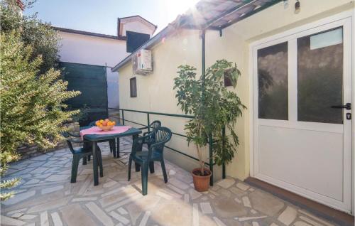 a patio with a table and chairs next to a door at One-Bedroom Holiday Home In Rogotin in Rogotin