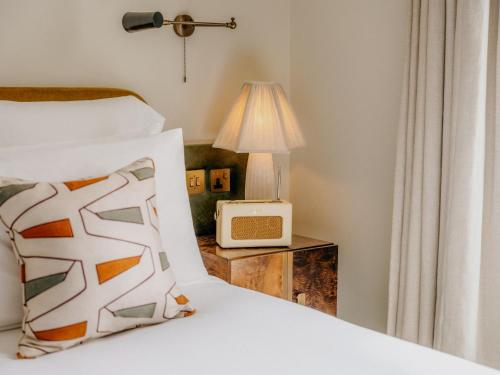 a bedroom with a bed and a nightstand with a radio at Redchurch Townhouse in London