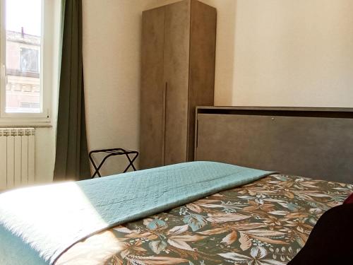 a bedroom with a bed with a headboard and a window at Al molo 21 in La Spezia