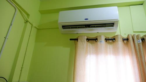 a room with a air conditioner and a window at Easy Stay Eranhipalam in Kozhikode