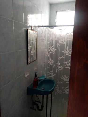 a bathroom with a blue sink and a shower at Casa Madrigal in Guanajuato