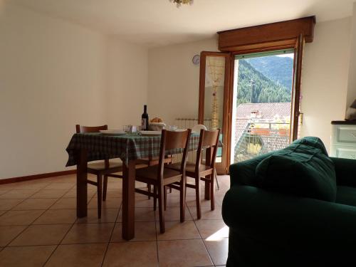 a dining room with a table and chairs and a window at Nido d'Aquila in Schilpario