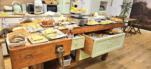 a buffet of food on a table in a kitchen at Napoli Tree - Lungomare in Naples