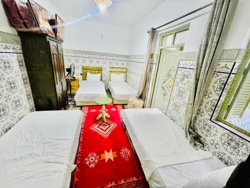 A bed or beds in a room at Riad Dar Lokman