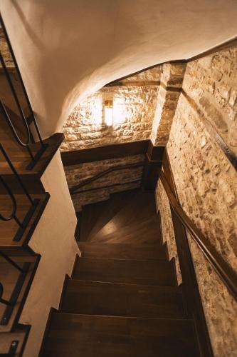 a staircase leading up to a building with stone walls at N'SOKAK Boutique Hotel in Gjirokastër