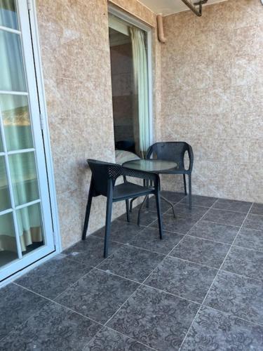 a table and a chair on a patio at Sea View Holiday House in Hong Kong