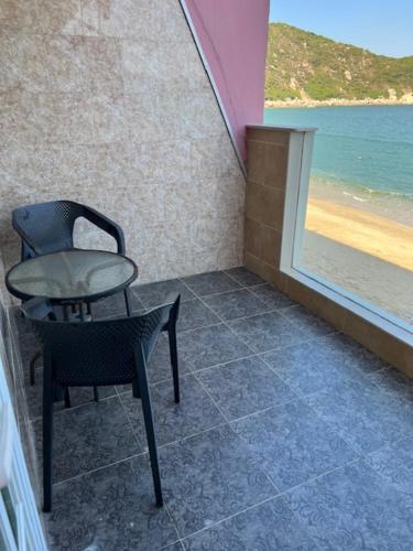 a room with a chair and a table and a window at Sea View Holiday House in Hong Kong