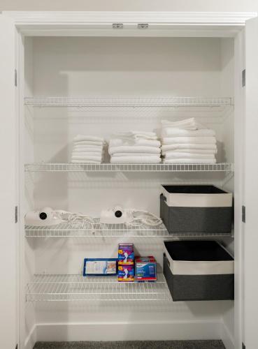 an open refrigerator with white towels and a drawer at A beautiful home in Airdrie in Airdrie