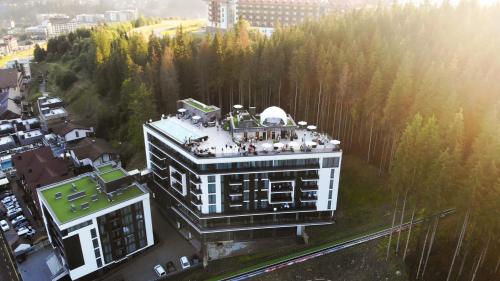 a building with a crowd of people on top of it at Rest&Ski Spa Resort in Bukovel