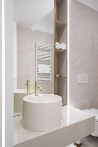 a white bathroom with a sink and a mirror at Silver SKY in Voluntari