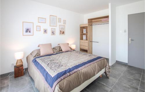 a bedroom with a large bed with pink pillows at Beautiful Home In Montélimar in Montélimar