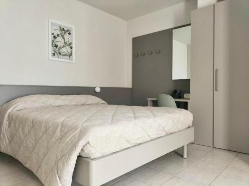a bedroom with a white bed and a desk at Locanda La Cavallina in Brisighella