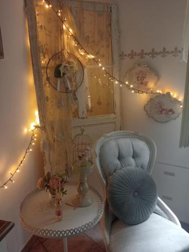 a room with a chair and a table and lights at B&B Luna in Castelvetro di Modena