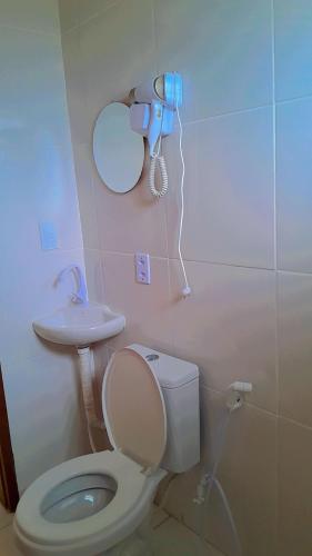 a bathroom with a toilet and a sink at PÉ NA AREIA Apto Vicenzo in Itapoa