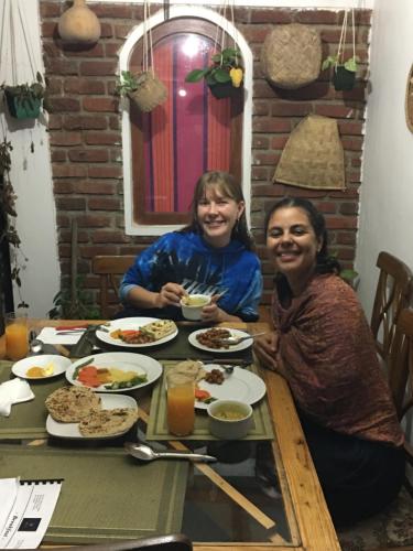 two women sitting at a table eating food at Villa25 Homestay free pick up from the centre in Kandy