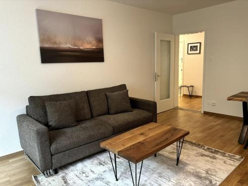 a living room with a couch and a coffee table at Cozy 2BR near Lake - Wille 8 in Zürich