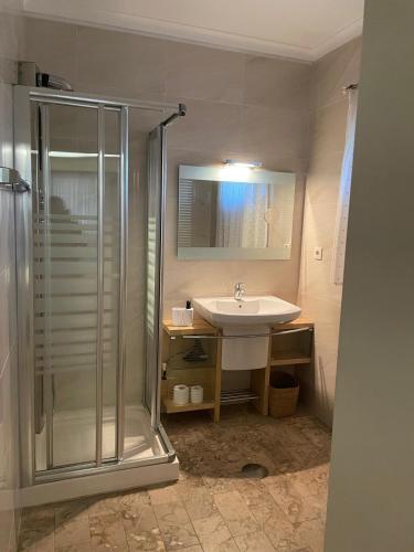 a bathroom with a sink and a shower at Casa da Avó Ilda - Angeiras Beach House in Lavra