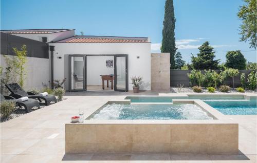 a pool in the backyard of a house at Cozy Home In Banjole With Wifi in Banjole
