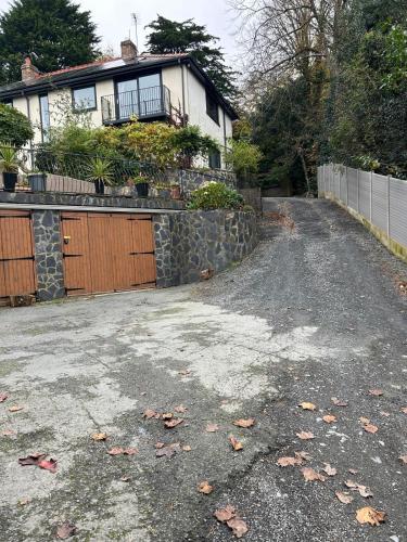 a driveway in front of a house with a fence at Bryn Mynach Annex in Barmouth