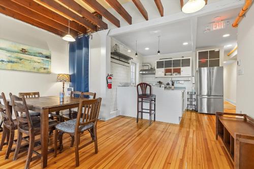 a kitchen and dining room with a table and chairs at Living on The Edge of Capitol Hill in Washington, D.C.