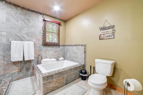 a bathroom with a tub and a toilet at Walk to Lake Dover Cabin with Views and Porch in Durham Subdivision