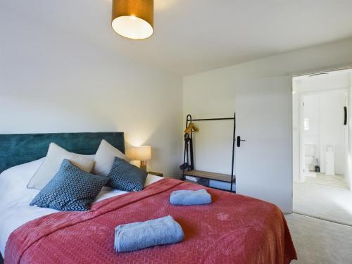 a bedroom with a large bed with two blue towels on it at 3 bed beautiful home which sleeps up to 6 in Tilehurst