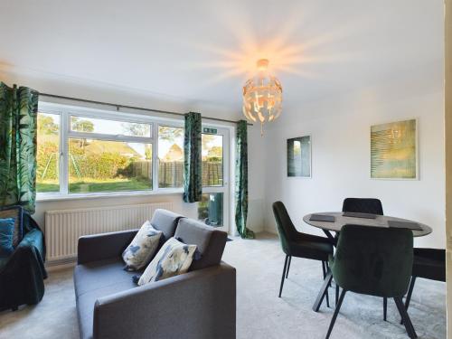 a living room with a couch and a table at 3 bed beautiful home which sleeps up to 6 in Tilehurst