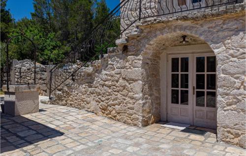 a stone building with a door and a stone wall at 2 Bedroom Lovely Home In Blato in Blato