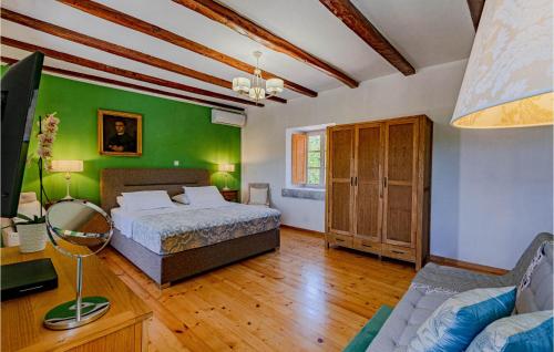 a bedroom with two beds and a green wall at 2 Bedroom Lovely Home In Blato in Blato