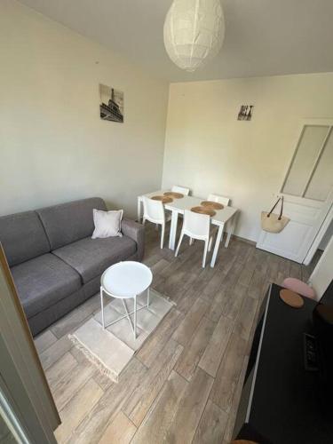 un salon avec un canapé et une table dans l'établissement GoodGuest- Cosy appartement Clichy, à Clichy