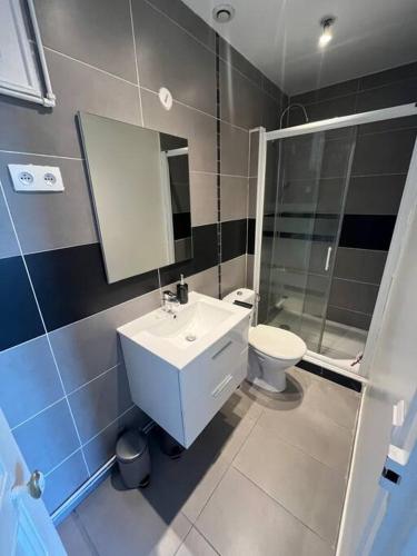 une salle de bain avec un lavabo, des toilettes et un miroir dans l'établissement GoodGuest- Cosy appartement Clichy, à Clichy
