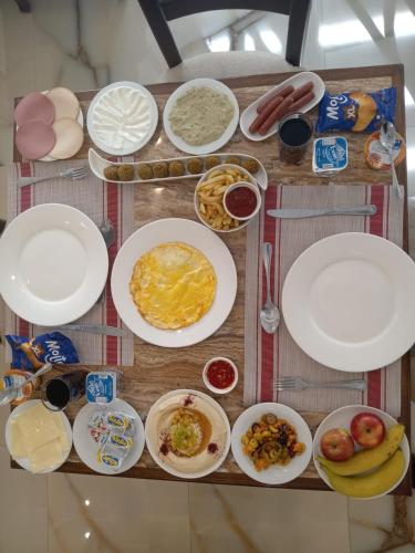 a table with plates of food on a table at Petra Premium Hotel in Wadi Musa