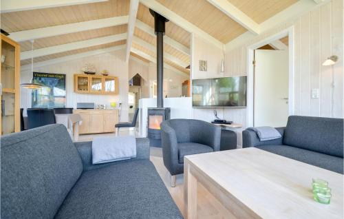 a living room with a couch and chairs and a table at Holiday Home Sofievej Knebel X in Skødshoved Strand
