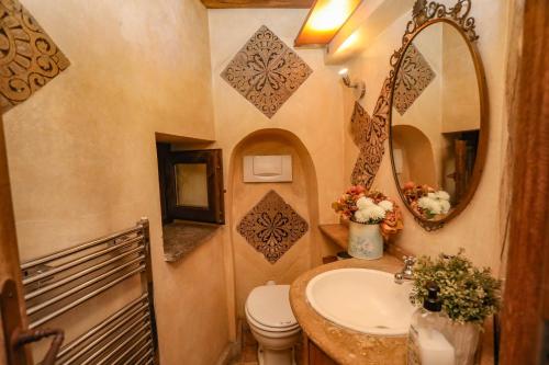 a bathroom with a sink and a toilet and a mirror at Domus Antica Navona in Rome
