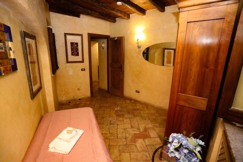 a hallway with a table and a mirror in a room at Domus Antica Navona in Rome
