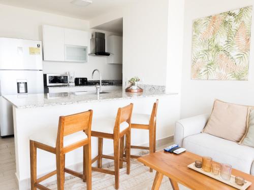 a kitchen and living room with a table and chairs at Ventanas del Mar by Playa Caracol 3 Habitaciones in Punta Chame