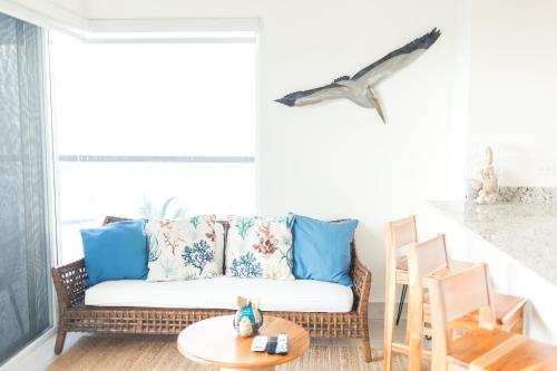a living room with a couch and a table at Ventanas del Mar by Playa Caracol 3 Habitaciones in Punta Chame