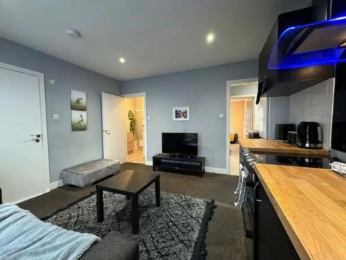 a kitchen and living room with a couch and a table at City Rd C - Central Location Long Stay by ShortStayUK in Bristol