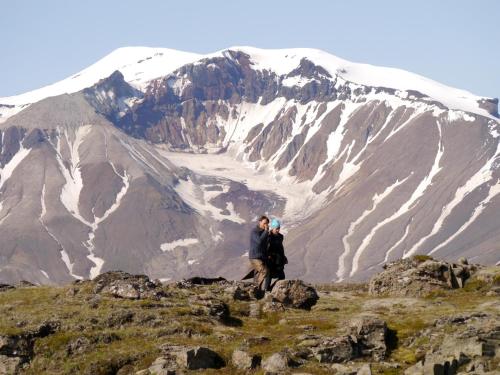 a man and woman standing on top of a mountain at Wilderness Center / Óbyggðasetur Íslands in Óbyggðasetur