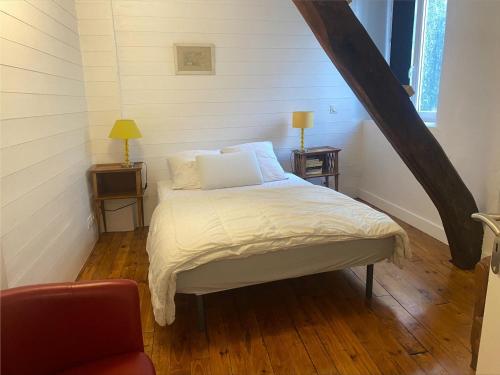 a bedroom with a bed with white sheets and a window at Appartement rénové au centre du Palais, proche plage et commodités - FR-1-418-226 in Le Palais
