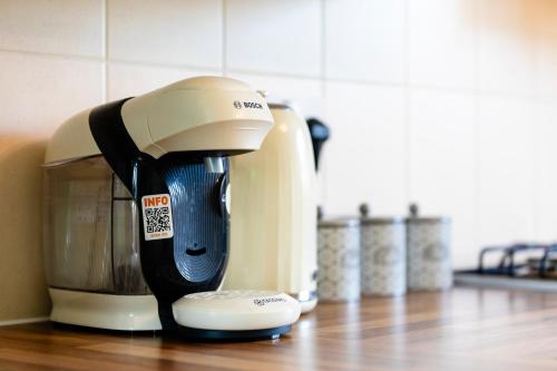a coffee maker sitting on a kitchen counter at Jungle House in Chichester