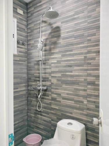 a bathroom with a shower with a toilet in it at House for Rent DailyMonthly in General Santos