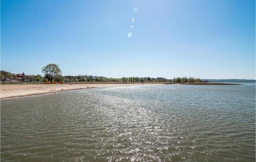 a body of water with a beach in the background at 2 Bedroom Beautiful Home In Frombork in Frombork