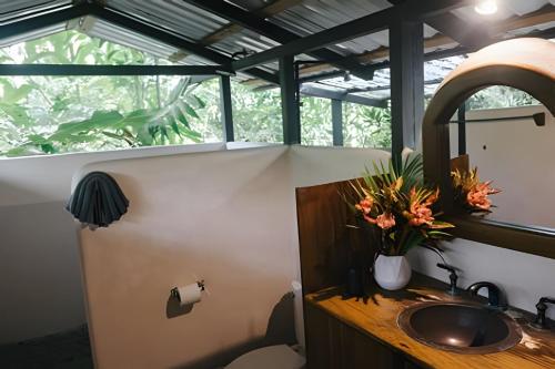 a bathroom with a sink and a window at Tumbo de las Olas in Cabo Matapalo
