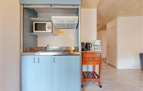 a kitchen with a sink and a microwave at Amazing Apartment In Usson-En-Forez With Kitchen in Usson-en-Forez